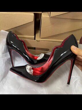 Black stiletto high heel red sole